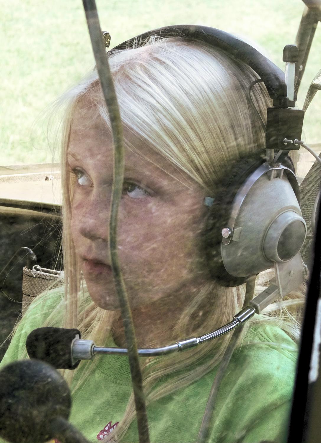 girl in airplane cockpit - A budding pilot is quite serious. - Panasonic DMC-FZ28 -- At the Flying Circus - Bealton Virginia - Tony Karp, design, art, photography, techno-impressionist, techno-impressionism, aerial photography , drone , drones , dji , mavic pro , video , 3D printing - Books -